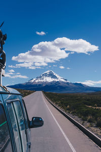 Road amidst mountains against sky