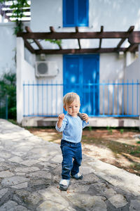 Full length of cute boy standing outdoors