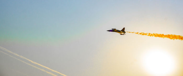 Low angle view of airplane flying against sky