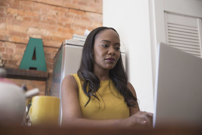 Businesswoman working on her laptop from home