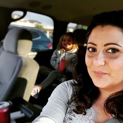 Portrait of woman sitting in car
