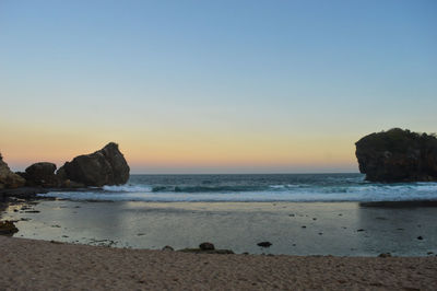 Scenic view of sea against clear sky during sunset