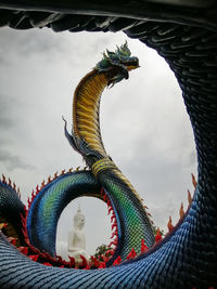 Low angle view of statue of liberty against cloudy sky