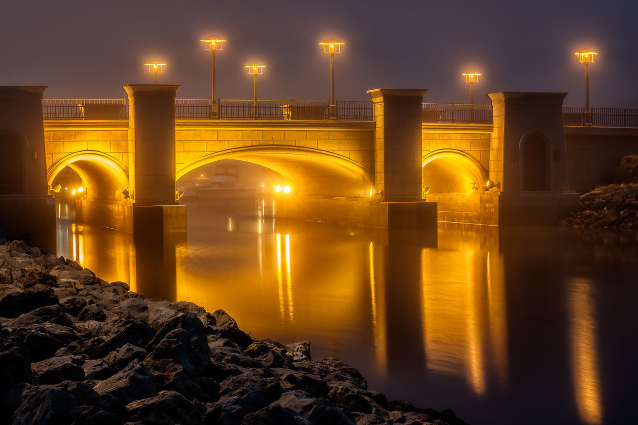 illuminated, reflection, travel, built structure, night, architecture, water, sky, connection, bridge - man made structure, arch, travel destinations, outdoors, no people, place of worship, nature, beauty in nature