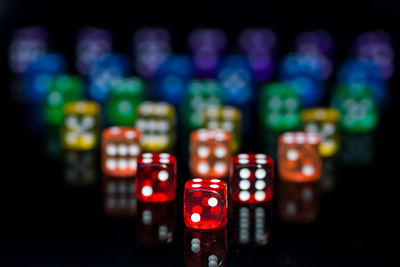 Close-up of multi colored dices on black background