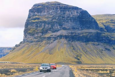 Cars on road against mountain