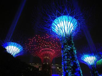 Low angle view of illuminated ferris wheel at night