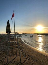 Scenic view of beach against sky during sunset