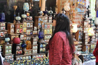 Woman looking at decorations in market