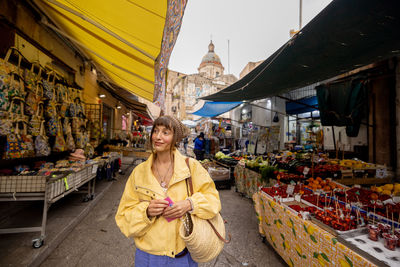 Rear view of woman standing in market