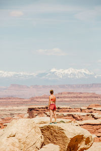 Rear view of man standing on rock