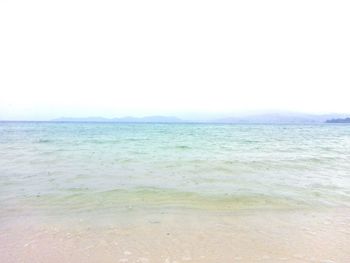 Scenic view of beach against blue sky