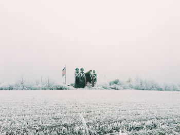 Scenic view of snow field against clear sky during winter