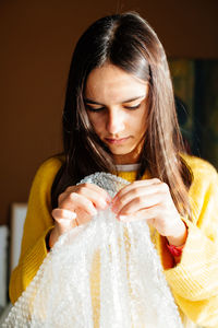 Girl playing with bubble wrap