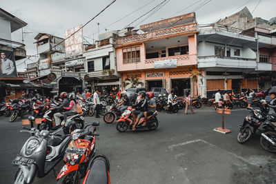 People riding bicycles on street in city