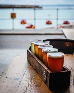 Close-up of beer in glasses on box at table