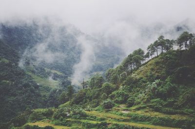 Scenic view of mountains against cloudy sky