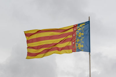 Low angle view of flag against sky