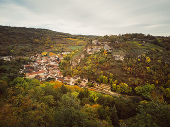 Scenic view of trees and buildings against sky