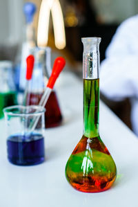 Close-up of scientific flask on table