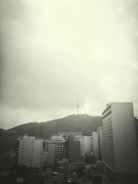 Cityscape against cloudy sky