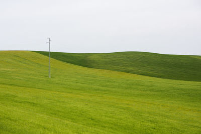 Scenic view of golf course against sky