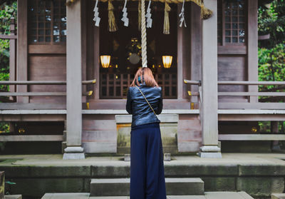 Full length of young woman on cross