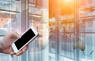 Digital composite image of man using mobile phone