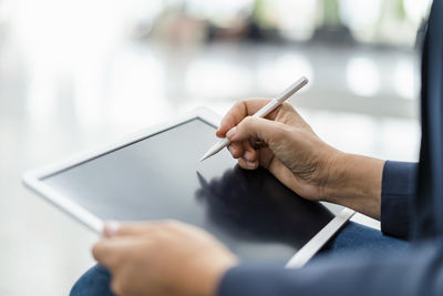 Businesswoman using digitized pen on tablet pc