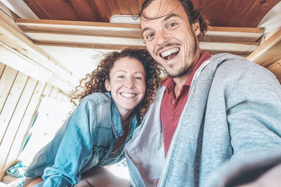 Portrait of smiling couple in mini van