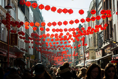 Lanterns hanging over people in city