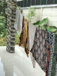 Close-up of clothes drying against the wall