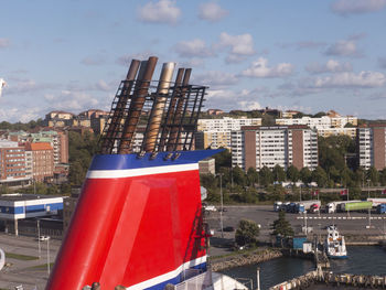 Red flag by building against sky in city