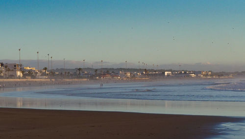 Scenic view of beach against blue sky