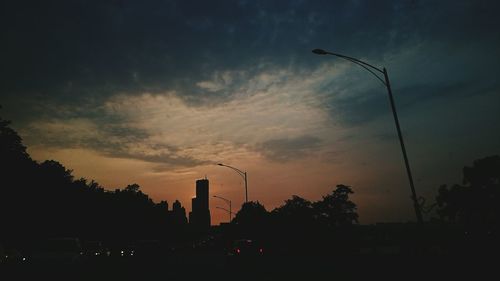 Low angle view of silhouette trees against sky at dusk