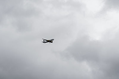 Low angle view of airplane flying in sky