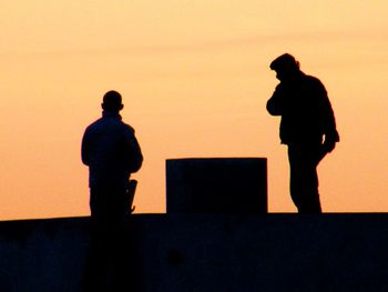 Silhouette people at sunset