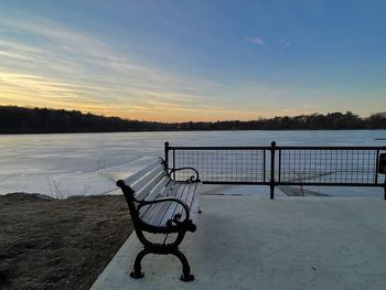 View of frozen lake against sky during sunset