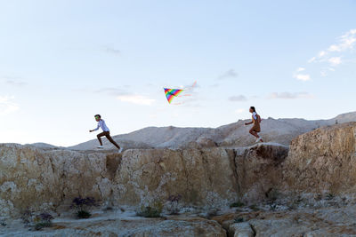 Low angle view of man standing on rock formation