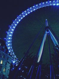 Low angle view of ferris wheel against sky at night