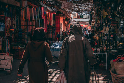 Rear view of people walking in market