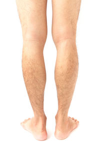 Low section of woman legs against white background