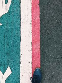 Low section of person standing on road