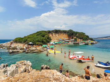 People on beach against sky