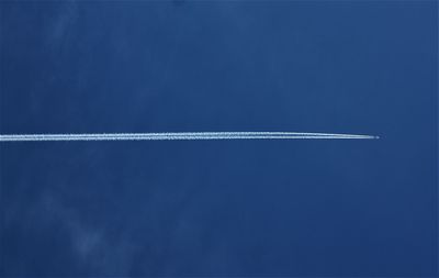 Vapor trail against blue sky