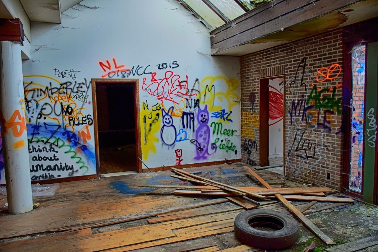 architecture, built structure, graffiti, building exterior, door, house, wall - building feature, art, wall, text, indoors, creativity, window, art and craft, abandoned, building, wood - material, multi colored, no people, blue