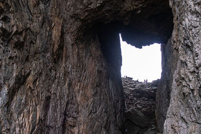 Rock formation seen through hole in cave