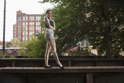 A young woman standing on a bench