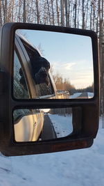 Reflection of sky on side-view mirror