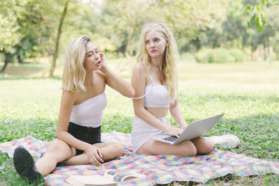 Young women sitting at park